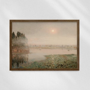 May include: A framed painting depicting a misty landscape with a lake in the foreground. The lake is surrounded by trees and a small village in the distance. The sky is a soft, pale blue with a single, bright sun shining through the clouds.