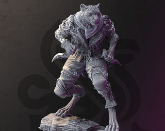 May include: A gray, detailed figurine of a wolf-like creature wearing armor and holding a dagger. The figurine is standing on a rocky base.