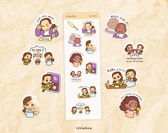 May include: A sheet of colorful stickers featuring characters and quotes from the musical "Hamilton." The stickers include illustrations of characters with phrases like "Just you wait," "Wait for it," and "My name is Philip!"
