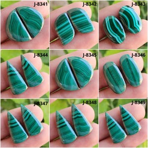 May include: A collection of nine pairs of polished malachite gemstones, each with unique patterns of dark and light green bands. The gemstones are in various shapes, including oval, teardrop, and rounded forms. Each pair is labeled with a "J" followed by a number.