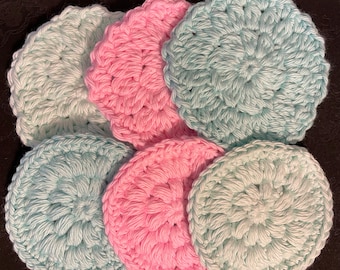 May include: Six crocheted cotton rounds in two colors: light blue and pink. The rounds are all the same size and have a raised, textured pattern.