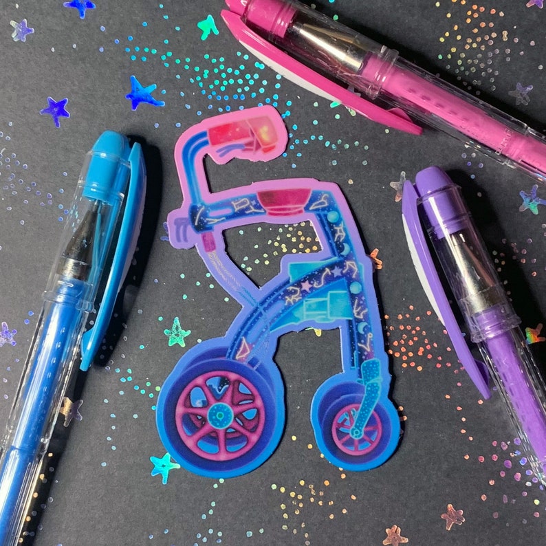 A die-cut sticker of a wheeled, rolling walker in shades of purple, pink, and blue. The walker is decorated with stars, constellations, and moon phases.