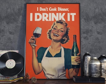 May include: A vintage-style poster with a woman in a white apron holding a glass of red wine and a bottle of wine. The poster has a red background and the text "I Don't Cook Dinner, I DRINK IT".