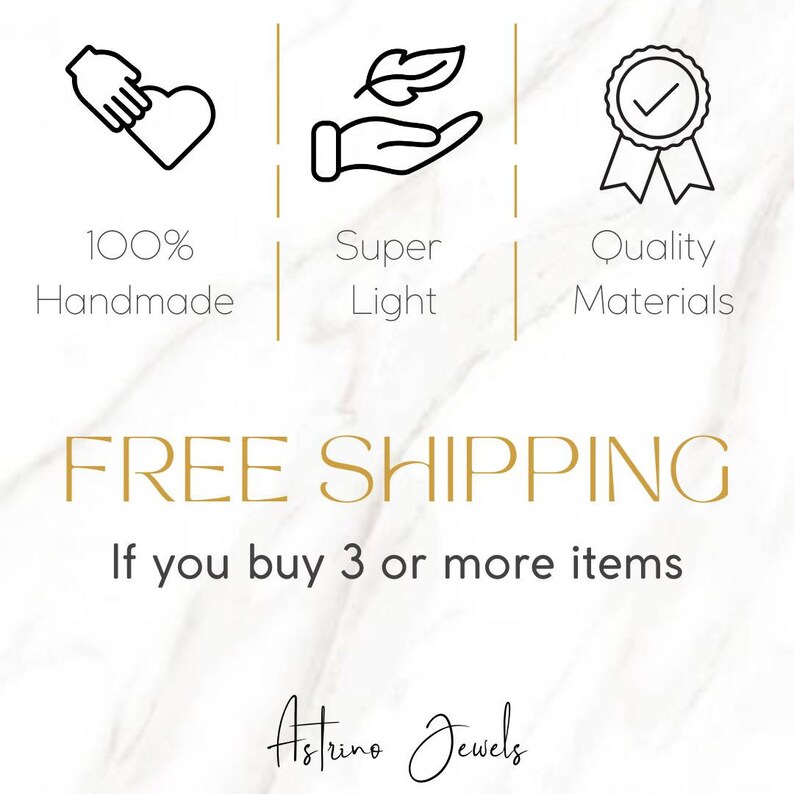 May include: Illustration of three icons representing the benefits of buying handmade jewelry. The first icon shows a hand holding a heart with the text "100% Handmade". The second icon shows a hand holding a leaf with the text "Super Light". The third icon shows a medal with a checkmark and the text "Quality Materials". The text "FREE SHIPPING" is displayed in gold letters below the icons. The text "If you buy 3 or more items" is displayed in black letters below the "FREE SHIPPING" text. The text "Astrine Jewels" is displayed in black cursive letters below the previous text.