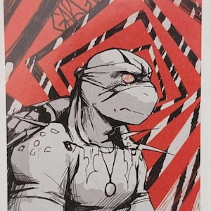 May include: Illustration of a Teenage Mutant Ninja Turtle in a comic book style. The artwork is primarily black, white, and red, with the turtle's face and body in grayscale. The background features a red and black geometric pattern. The text "ARTISTIC GARGOYLE" is at the bottom.