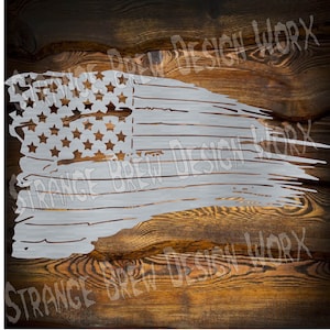 May include: A distressed, white, American flag design with a faded, worn look. The flag is on a wood background.
