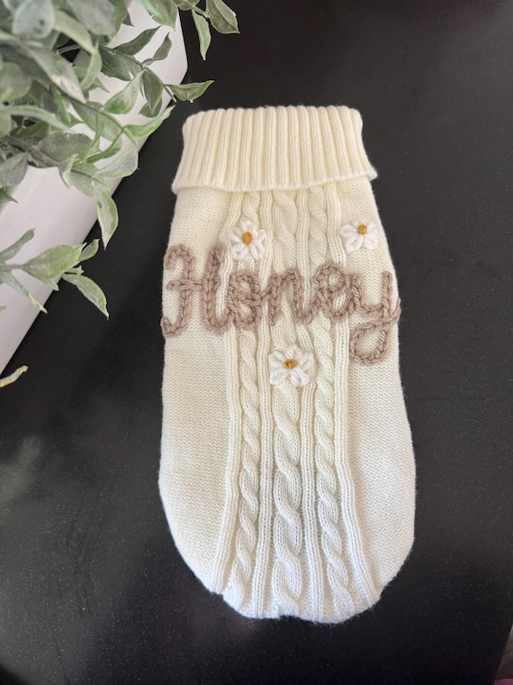 A tiny dog or cat sweater hand-embroidered with your pet's name — 103 favorites don't lie; this is the personalized keepsake pet parents didn't know they needed.