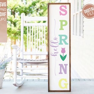 May include: A wooden sign with the word "hello" and the word "SPRING" spelled out vertically with each letter in a different pastel color. A pink tulip with green leaves is between the "R" and the "I".