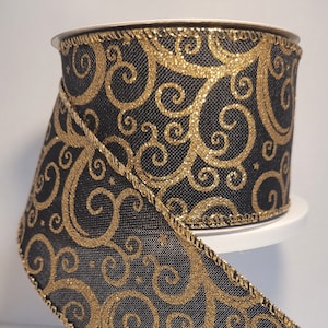 2.5 inch 10 yd Gold glitter swirls on black background with gold edging. use this ribbon in a contemporary setting.