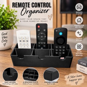 May include: A black rectangular remote control organizer featuring six individual storage slots. The organizer is constructed with a durable material and includes cutouts on the front edges for easy access to stored items like remote controls.
