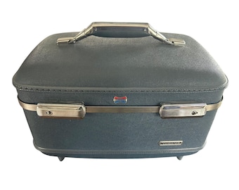 Maleta de viaje American Tourister vintage, color azul, rígida, con estampado floral, años 60.