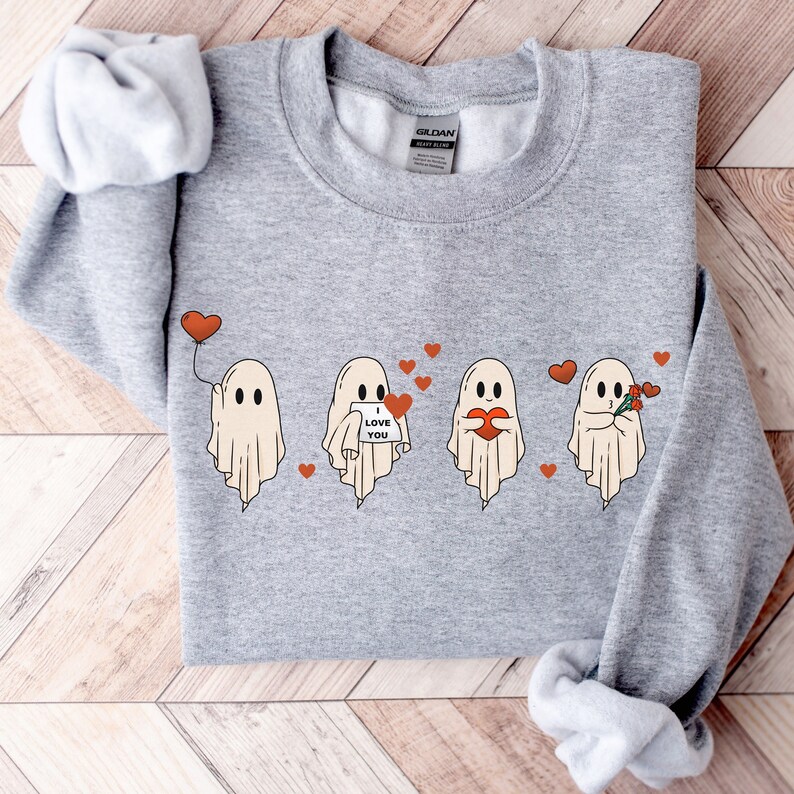 May include: A gray sweatshirt with a graphic of four ghosts expressing love. The ghosts are holding hearts, flowers, and a sign that says "I love you".