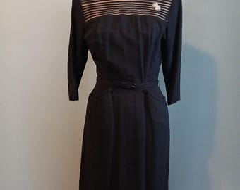 Black 1960s wiggle dress with sheer detailed yoke, rhinestone button accent, bust 38