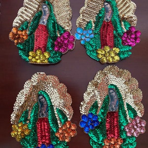 May include: Four embroidered patches featuring the Virgin Mary, each with a different color scheme of sequins and beads. The patches are oval-shaped and have a gold background.