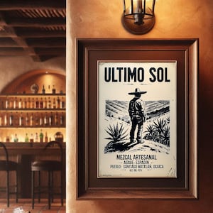 May include: A framed black and white print with the text "ULTIMO SOL" and a depiction of a person in a hat overlooking a landscape with agave plants. The print also includes the text "MEZCAL ARTESANAL" and other details.