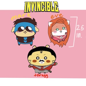May include: A pink background features three cartoon characters from the Invincible series. The characters are drawn in a cute style, with the text "INVINCIBLE" at the top. The image includes a 2.5-inch measurement.