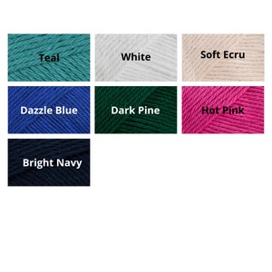 May include: A collection of yarn skeins in various colors, including teal, white, soft ecru, dazzle blue, dark pine, hot pink, and bright navy.