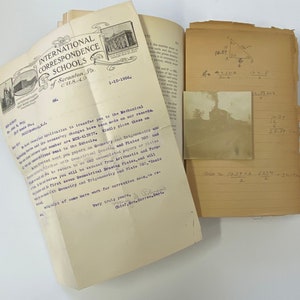 May include: A vintage letter from the International Correspondence Schools dated January 10, 1906, informing a student about their transfer to the Mechanical Drawing course. The letter is folded and has a handwritten signature at the bottom. A second image shows a black and white photograph of a building with a smokestack.