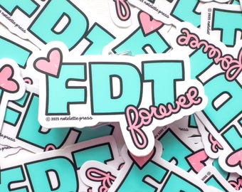 May include: A collection of stickers with a teal and black design. The stickers feature the letters "FDT" with a pink heart and the word "forever" in a cursive font. The stickers are from "2025 notelette press".