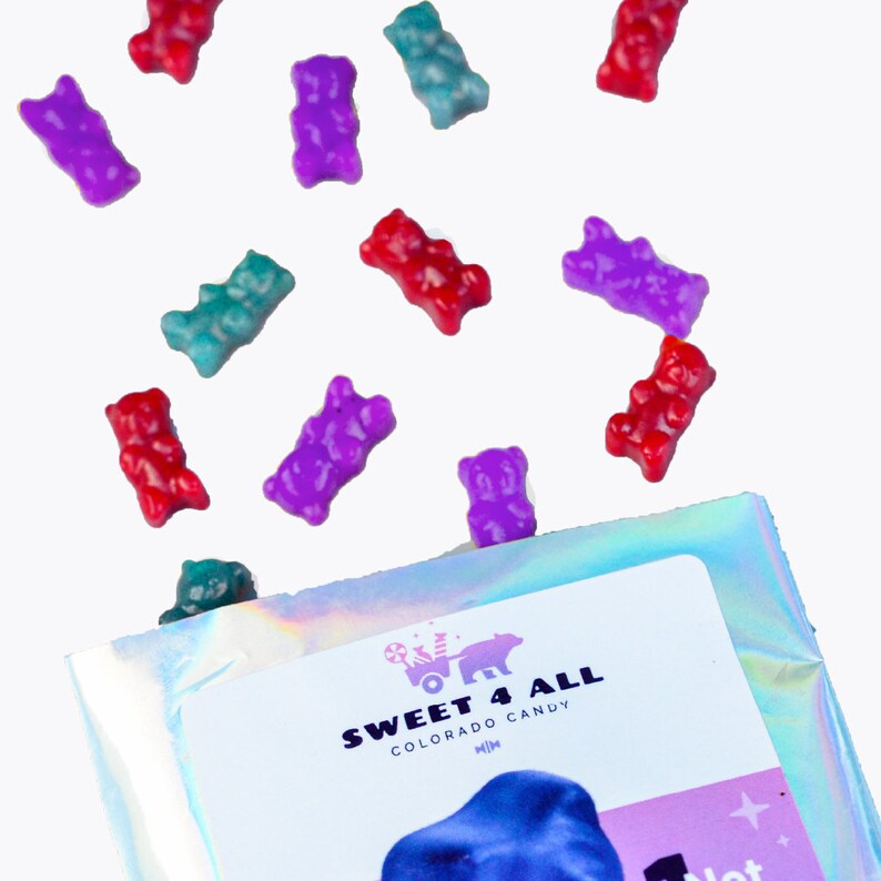 May include: A bag of gummy bears in assorted colours, including red, purple, blue, and green. The bag is labelled "Sweet 4 All Colorado Candy".