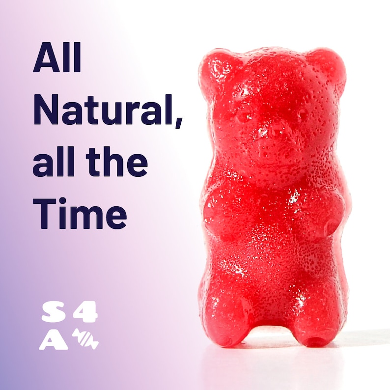 May include: A red gummy bear sweet shaped like a bear. The text "All Natural, all the Time" is visible in the background. The text "S4A" is also visible in the background.