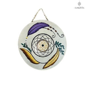 May include: A round, white dreamcatcher with a beaded fringe and three feathers. The feathers are purple, yellow, and gold. The dreamcatcher is hanging from a rope.