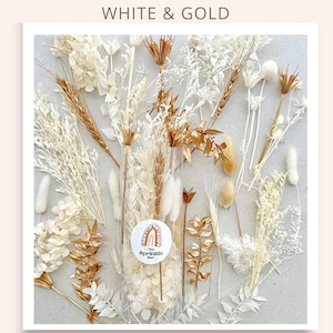 May include: A clear plastic bag filled with dried white and gold flowers. The bag is labeled "The Sprinkle Bar".