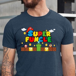 May include: A navy blue t-shirt with a graphic of a video game character and the text "SUPER FUNCLE".