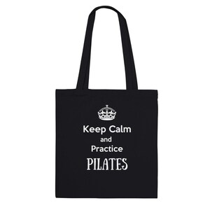 May include: Black tote bag with white text that reads "Keep Calm and Practice PILATES".