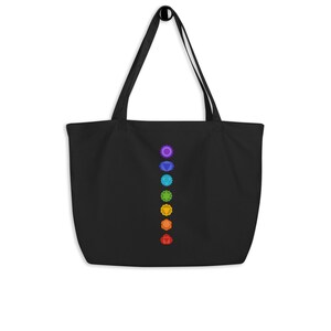 May include: Black tote bag featuring a vertical row of seven colourful chakra symbols.