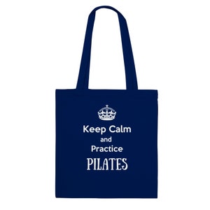 May include: A navy blue tote bag with white text that reads "Keep Calm and Practice PILATES".