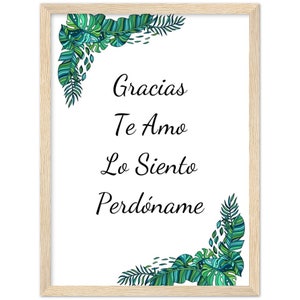 Puede incluir: Un cuadro enmarcado con fondo blanco y las palabras "Gracias, Te Amo, Lo Siento, Perdóname" en escritura negra. Hojas tropicales verdes y azules decoran las esquinas. El marco es de madera clara.