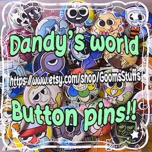 May include: A collection of colorful button pins with cartoon character designs. The pins feature various characters with unique expressions and color schemes. Text on the pins reads "Dandy's world" and "Button pins!!" with a shop URL.