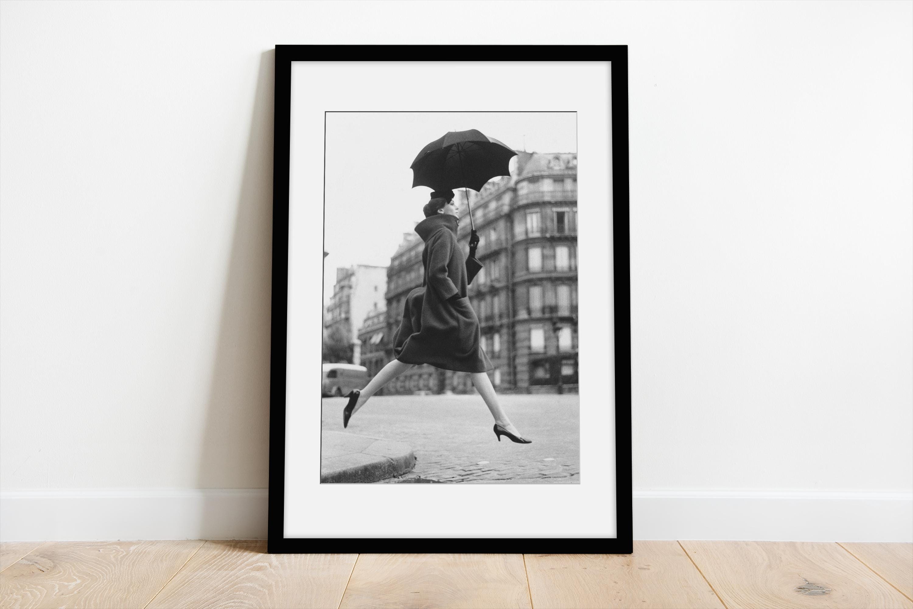 Carmen jumping over a puddle in the street with an umbrella | Richard Avedon | Matted Gallery Frame | Mounted & Framed Fine Art photo