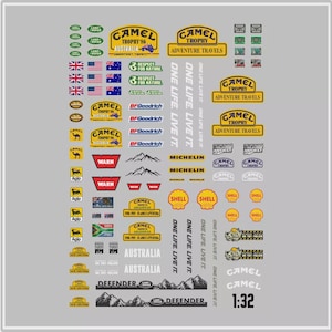 May include: A collection of decals with logos and text associated with the Camel Trophy off-road racing event. Includes logos for Camel Trophy, BFGoodrich, Michelin, Shell, and Warn. Also features flags and text such as "Australia" and "Defender".