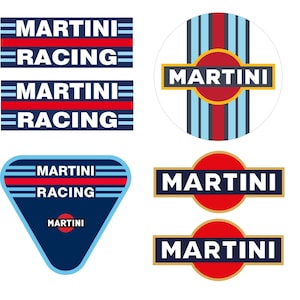 May include: A set of six Martini Racing decals. The decals are in various shapes and sizes, including a circle, a triangle, and a rectangle. The decals are all blue, red, and white with the text "Martini Racing" in white.