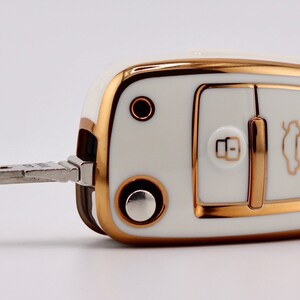 Front facing angle of White key cover on Audi key fob with the key out.