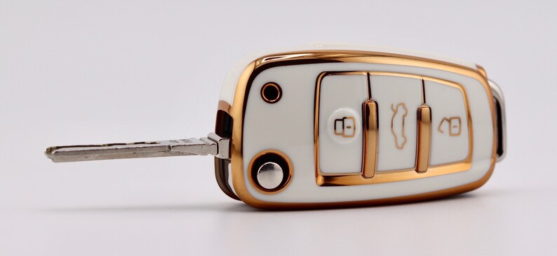 Front facing angle of White key cover on Audi key fob with the key out.