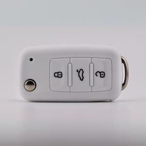May include: A white rectangular car key fob featuring three buttons with black icons representing a locked padlock, an open trunk, and an unlocked padlock. A small circular silver button is on the left, and a metal keyring loop is on the right.