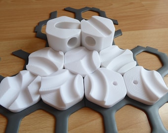 May include: White plastic puzzle pieces with a textured surface fit together on a gray honeycomb-shaped base.