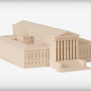 May include: A beige 3D printed model of a classical building with columns and a large roof. The building has many windows and a set of stairs leading up to the entrance.