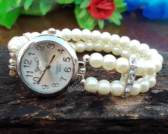Reloj de pulsera con perlas de agua dulce y correa elástica de acero inoxidable para mujer.