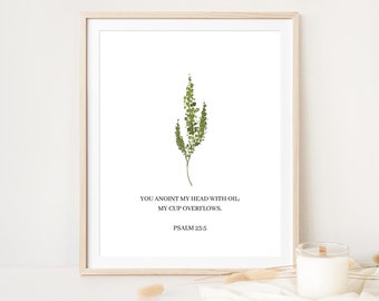 May include: A framed print with a green botanical illustration and the text "YOU ANOINT MY HEAD WITH OIL; MY CUP OVERFLOWS. PSALM 23:5"