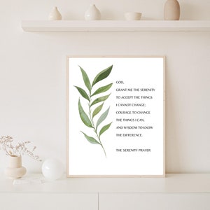 May include: A white printable art print with a green leafy branch on the left side and the Serenity Prayer text in black font on the right side. The text reads: "GOD, GRANT ME THE SERENITY TO ACCEPT THE THINGS I CANNOT CHANGE; COURAGE TO CHANGE THE THINGS I CAN; AND WISDOM TO KNOW THE DIFFERENCE. THE SERENITY PRAYER."
