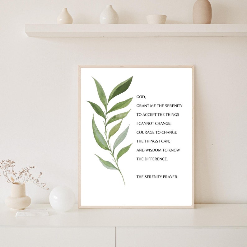 May include: A white printable art print with a green leafy branch on the left side and the Serenity Prayer text in black font on the right side. The text reads: "GOD, GRANT ME THE SERENITY TO ACCEPT THE THINGS I CANNOT CHANGE; COURAGE TO CHANGE THE THINGS I CAN; AND WISDOM TO KNOW THE DIFFERENCE. THE SERENITY PRAYER."