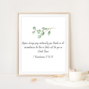 May include: A printable wall art design with a watercolor illustration of a eucalyptus branch and a quote from the Bible: "Rejoice always, pray continually, give thanks in all circumstances. For this is God's will for you in Christ Jesus. 1 Thessalonians 5:16-18"