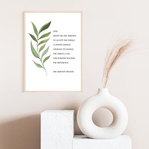 May include: A framed print with a watercolor illustration of a green leafy branch and the text "GOD, GRANT ME THE SERENITY TO ACCEPT THE THINGS I CANNOT CHANGE: COURAGE TO CHANGE THE THINGS I CAN, AND WISDOM TO KNOW THE DIFFERENCE. THE SERENITY PRAYER"
