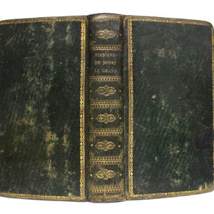 May include: A vintage green leather-bound book with gold accents and the title "HISTOIRE DE HENRI LE GRAND" on the spine.