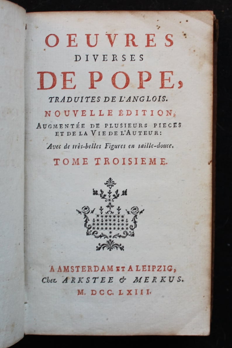 May include: A book cover with the title "OEUVRES DIVERSES DE POPE, TRADUITES DE L'ANGLOIS. NOUVELLE &Eacute;DITION, AUGMENT&Eacute;E DE PLUSIEURS PIECES ET DE LA VIE DE L'AUTEUR: Avec de tr&egrave;s-belles Figures en taille-douce. TOME TROISIEME."  The book was published in Amsterdam and Leipzig in 1763.