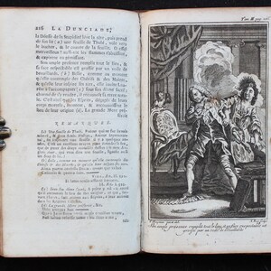 May include: A black and white illustration of a man and a woman in a room. The man is sitting in a chair and the woman is standing. The man is holding a book and the woman is pointing at something. The text "La Dunciade" is visible in the image.